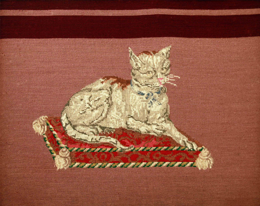 Click for larger image: Needlepoint / needlework / textile / tapestry of a cat recumbent upon a cushion. - Needlepoint / needlework / textile / tapestry of a cat recumbent upon a cushion.